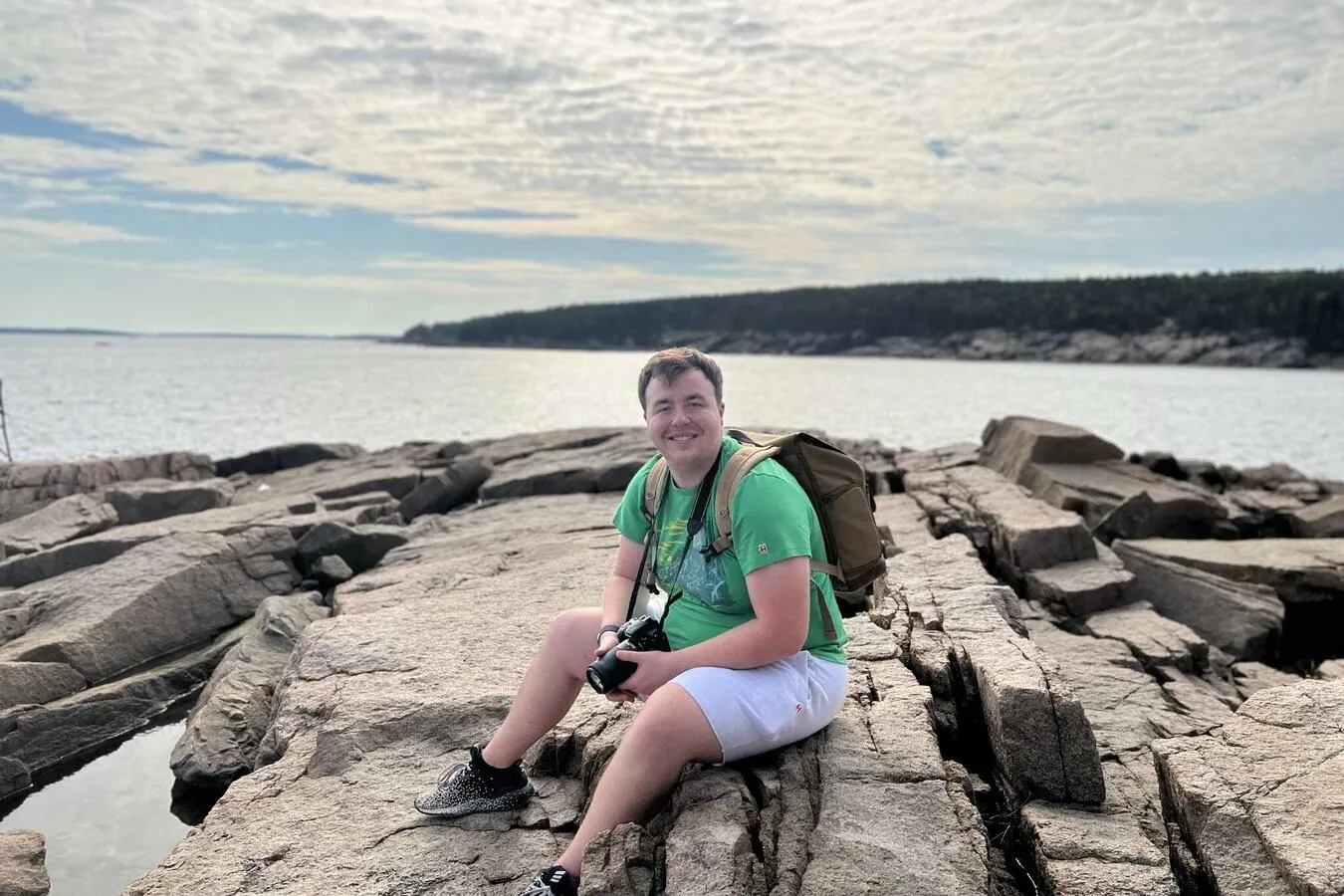 Me, sitting on a rocky seaside cliff.