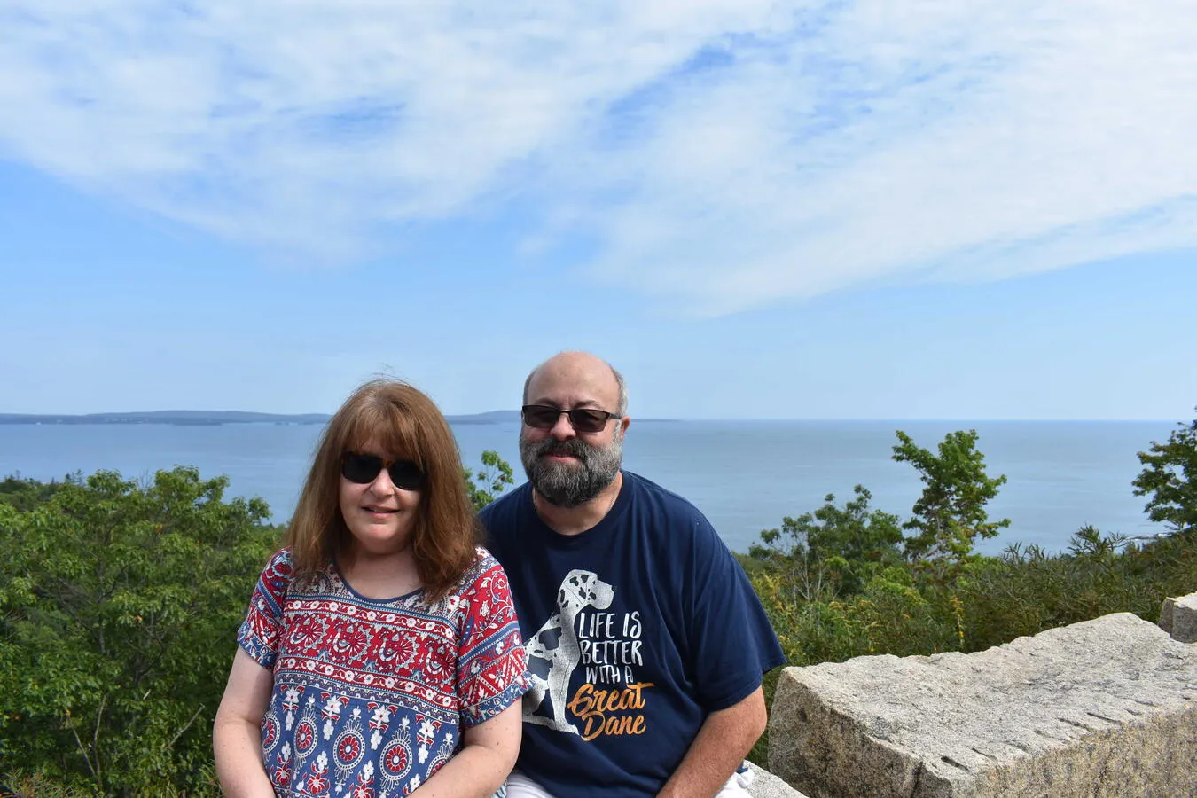 My mom and Dad posing for a picture at a scenic overlook of the Atlantic Ocean.